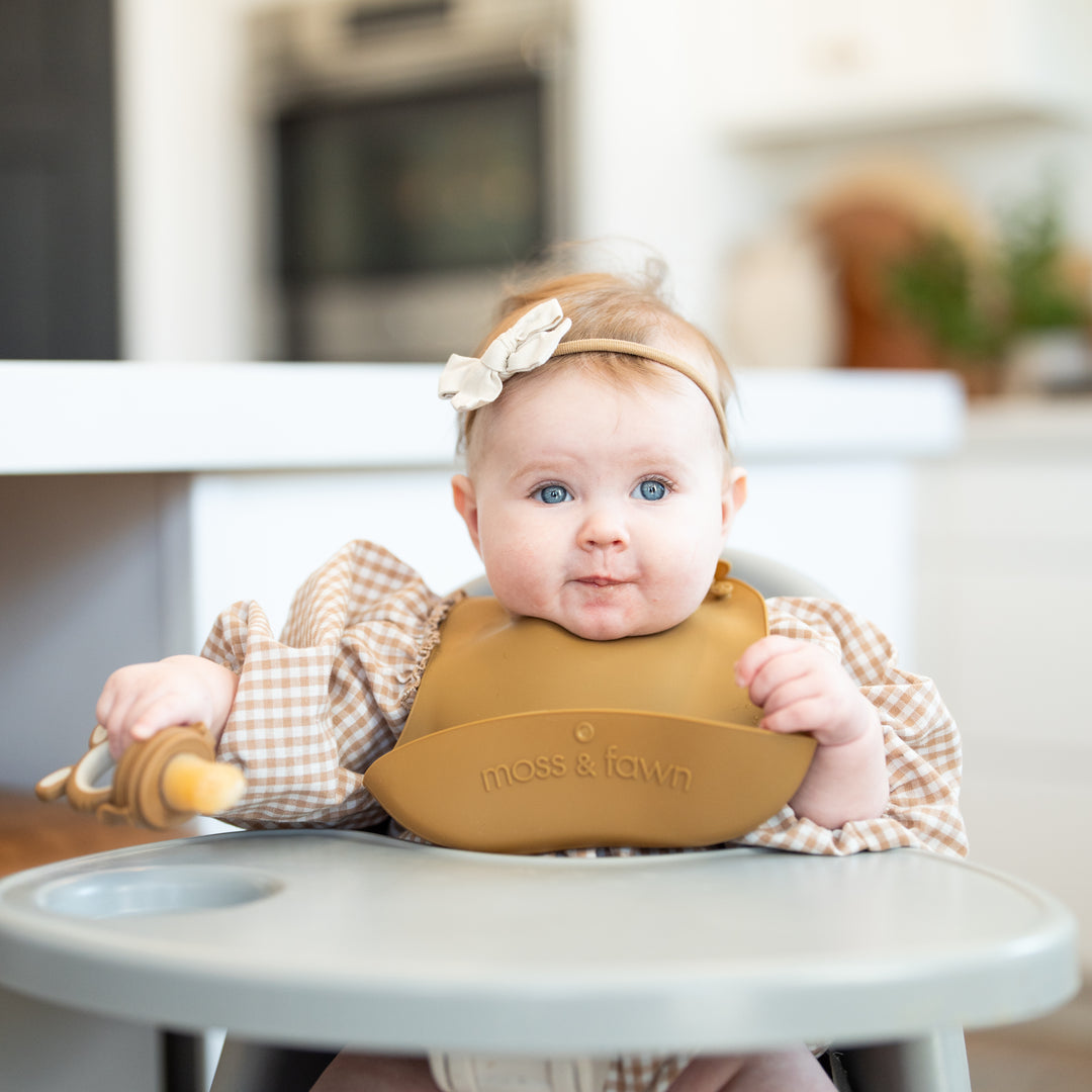 Teething baby using mesh feeder to self-soothe at home